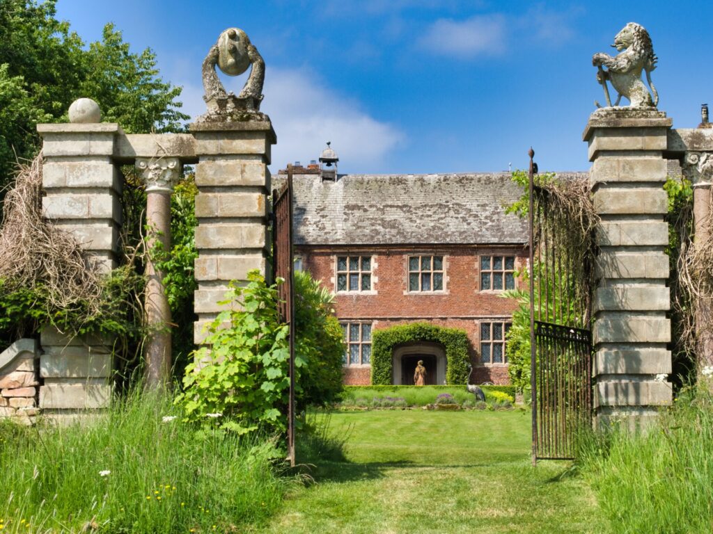 View of Hellens manor house through open gates
